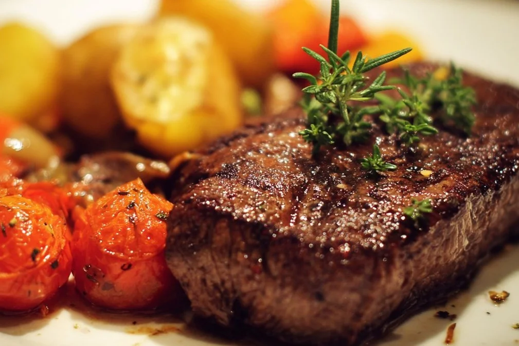 Delicious beef dinner served with sides and garnishes