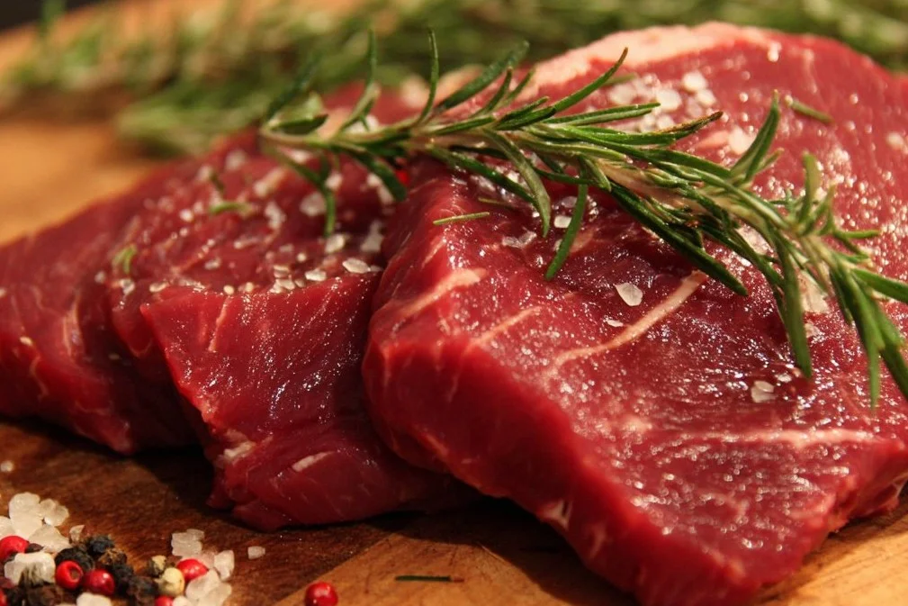 Perfectly cooked Beef Eye of Round Steak served with herbs and vegetables.