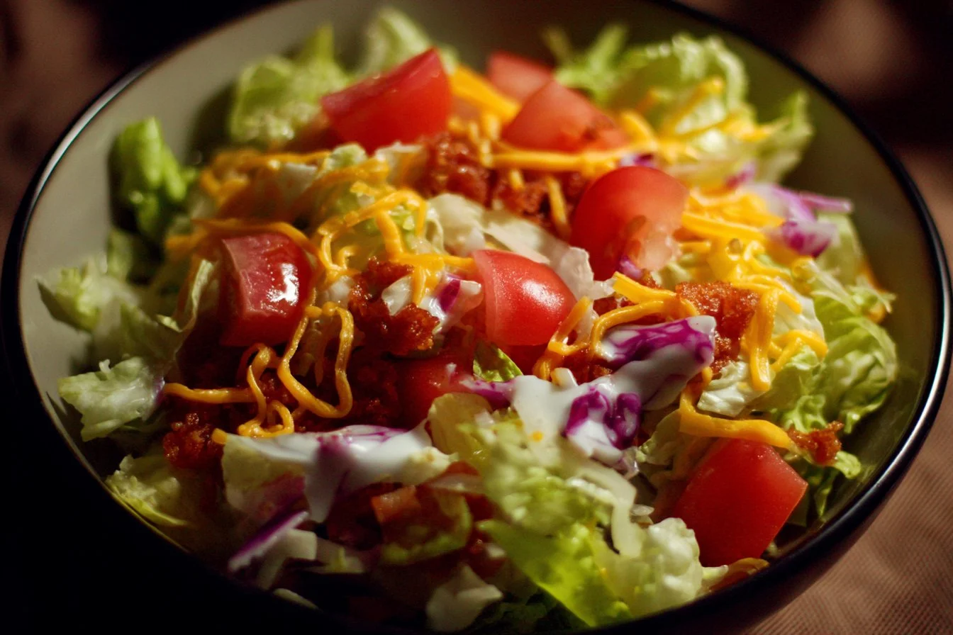Big Mac Salad featuring lettuce, tomatoes, cheese, and special sauce in a bowl