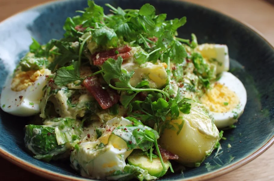 Fresh and vibrant Brussel Sprout Salad topped with nuts and dressing