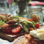 Variety of easy picnic food ideas laid out on a picnic blanket.