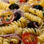 Delicious Greek Pasta Salad with olives, feta, and tomatoes in a bowl