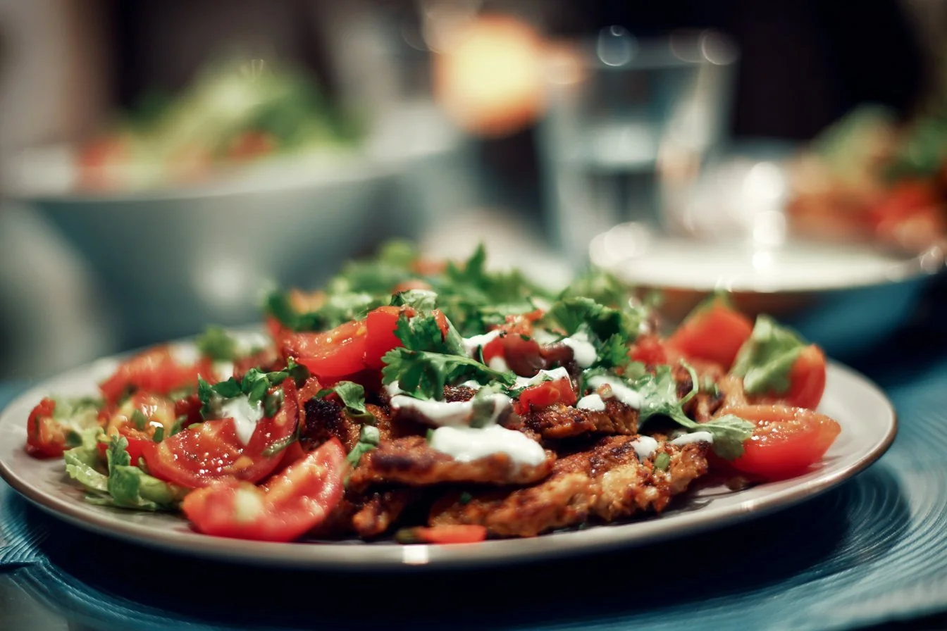 A plate of healthy summer dinner recipes featuring fresh vegetables and grilled chicken.