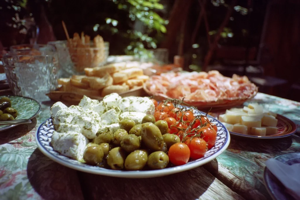 Italian Summer Party setup featuring decor, food, and guests enjoying the celebration.