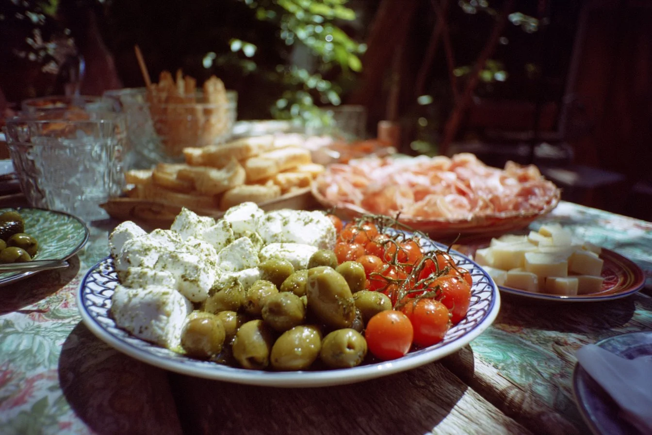 Italian Summer Party setup featuring decor, food, and guests enjoying the celebration.