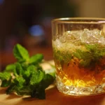 Refreshing Mint Julep cocktail served in a silver cup with fresh mint leaves