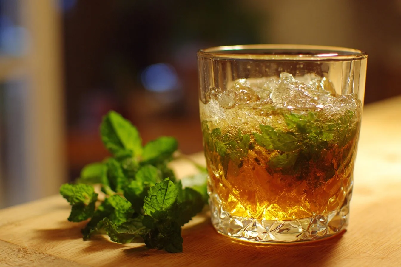 Refreshing Mint Julep cocktail served in a silver cup with fresh mint leaves