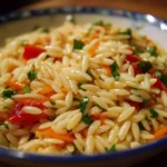 Delicious orzo salad with fresh vegetables and herbs