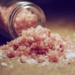 Delicious pink salt in a bowl promoting healthy cooking tips.