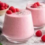 Colorful protein smoothies in a glass with fruits and protein powder.