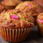 Delicious rhubarb muffins fresh out of the oven, topped with a sprinkle of sugar.