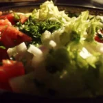 Fresh ingredients and toppings at a colorful salad bar