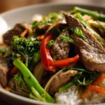Delicious sliced beef stir-fry with vibrant vegetables in a hot pan.