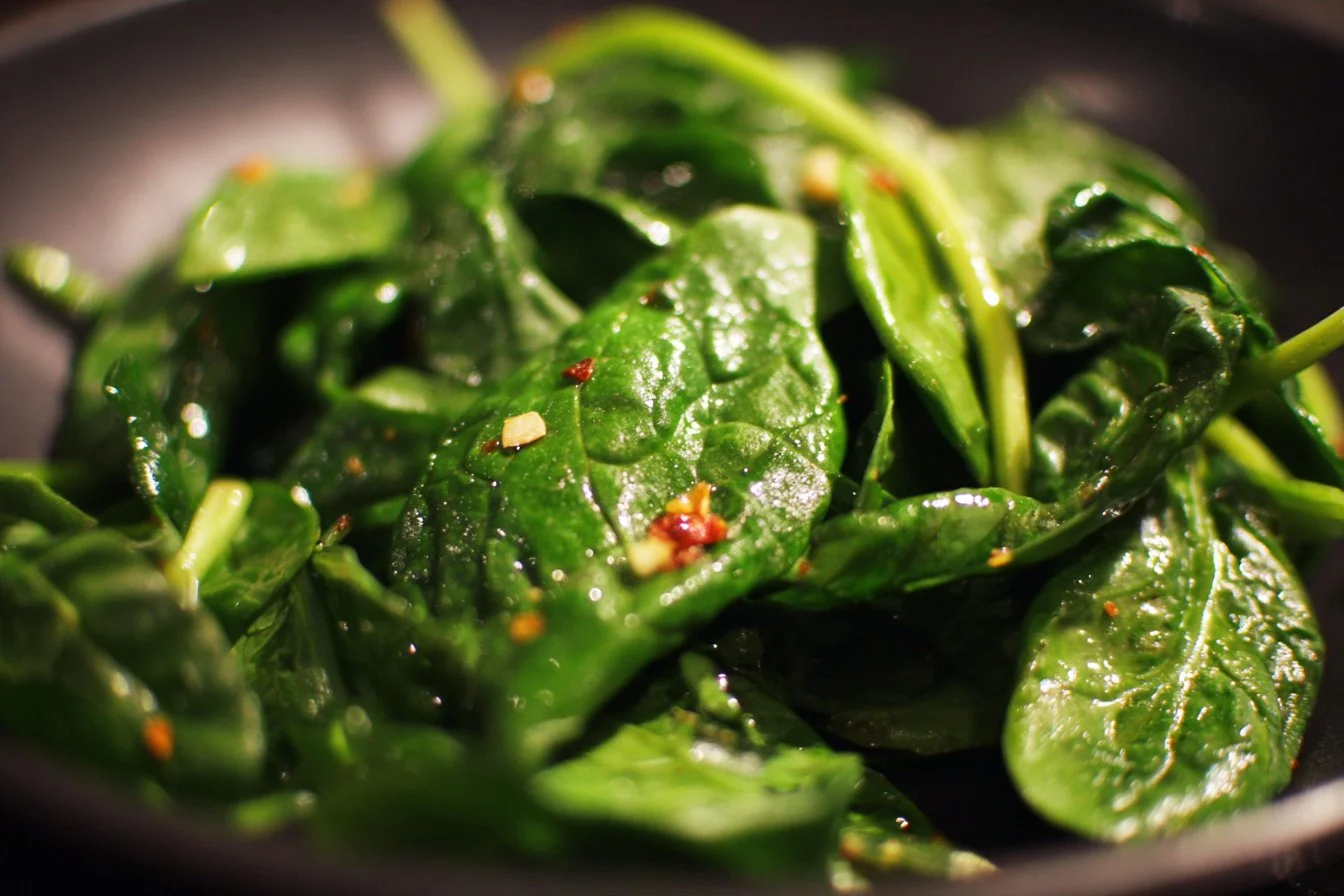 Fresh spinach salad with colorful vegetables and dressing
