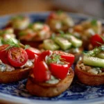 A colorful platter of summer appetizers featuring fresh fruits and bite-sized snacks.