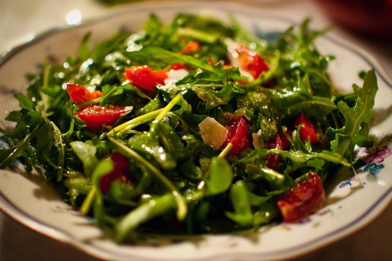 Fresh arugula salad with cherry tomatoes and a balsamic vinaigrette