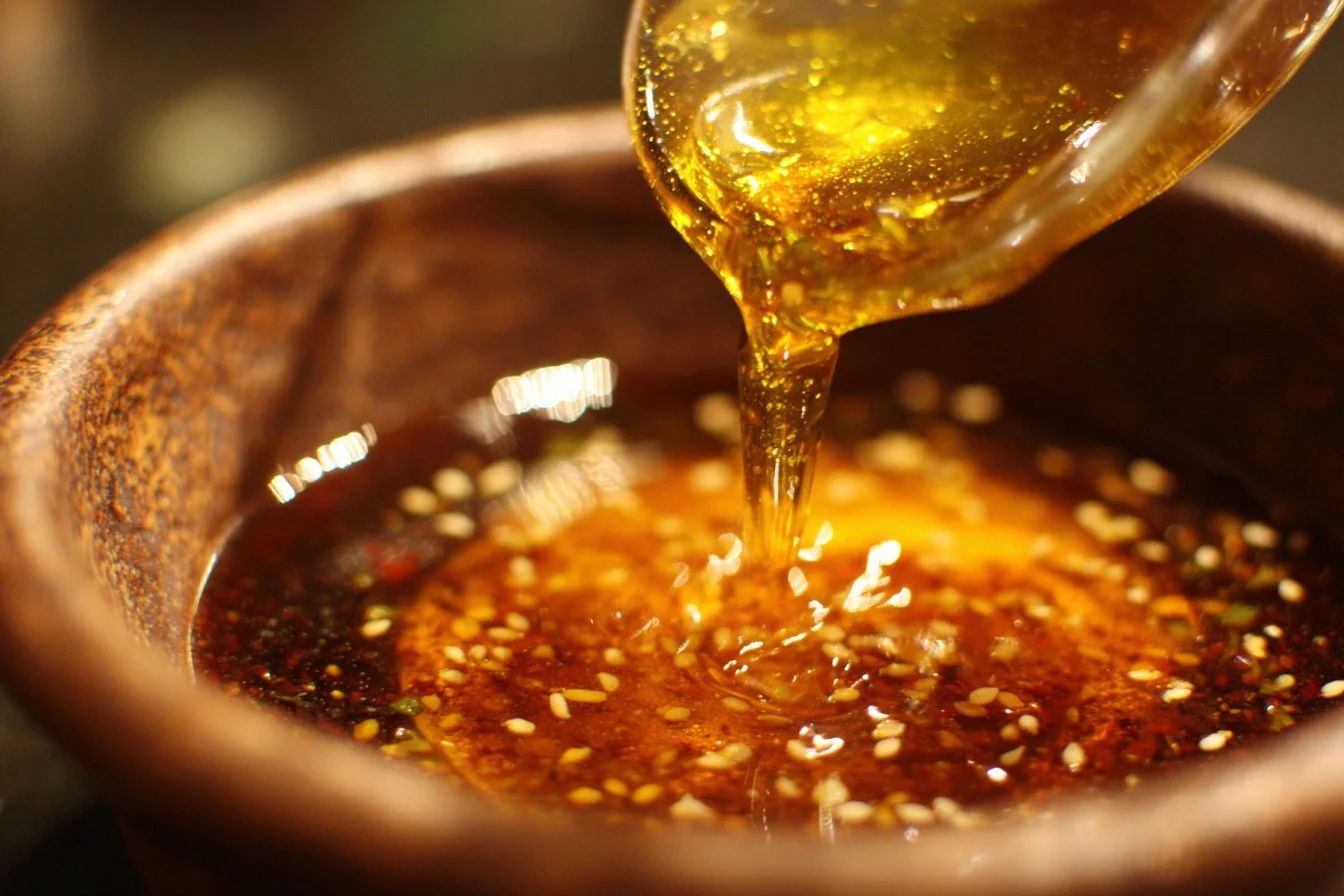 Homemade Asian salad dressing drizzled over a fresh salad
