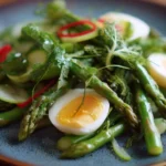 Fresh asparagus salad with cherry tomatoes and vinaigrette dressing