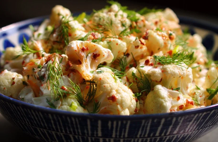 Fresh cauliflower salad with colorful vegetables and dressing