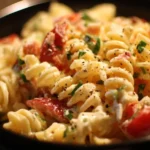 Bowl of easy cold pasta salad with vegetables and dressing.