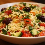Delicious Greek Orzo Salad with fresh vegetables and feta cheese