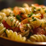 Colorful and fresh Pasta Salad with vegetables and dressing served in a bowl