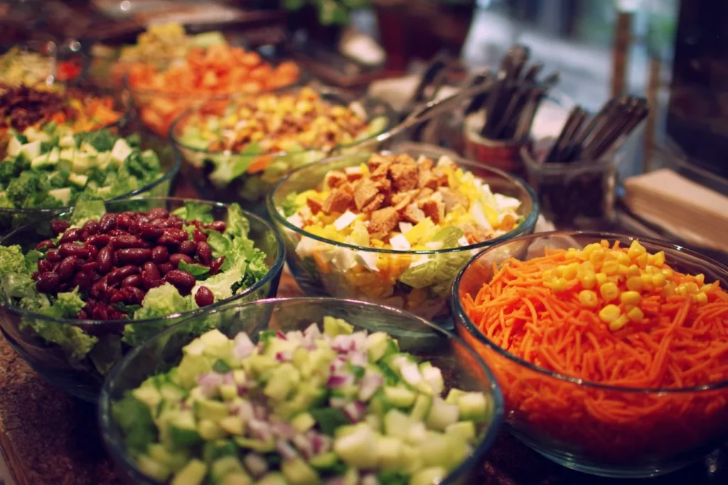 Colorful salad bar setup with fresh ingredients and toppings