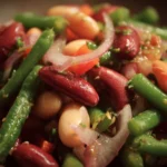 Colorful three bean salad with fresh vegetables in a bowl