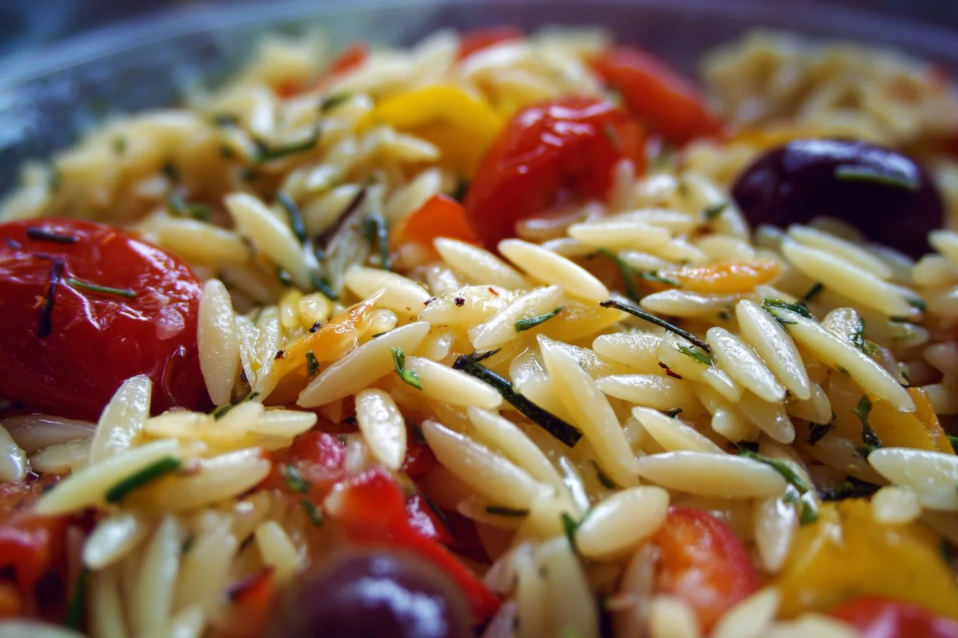 Colorful orzo salad with fresh vegetables and herbs