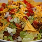 Delicious and colorful taco salad topped with fresh ingredients