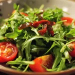 Fresh and vibrant arugula salad with colorful vegetables and dressing