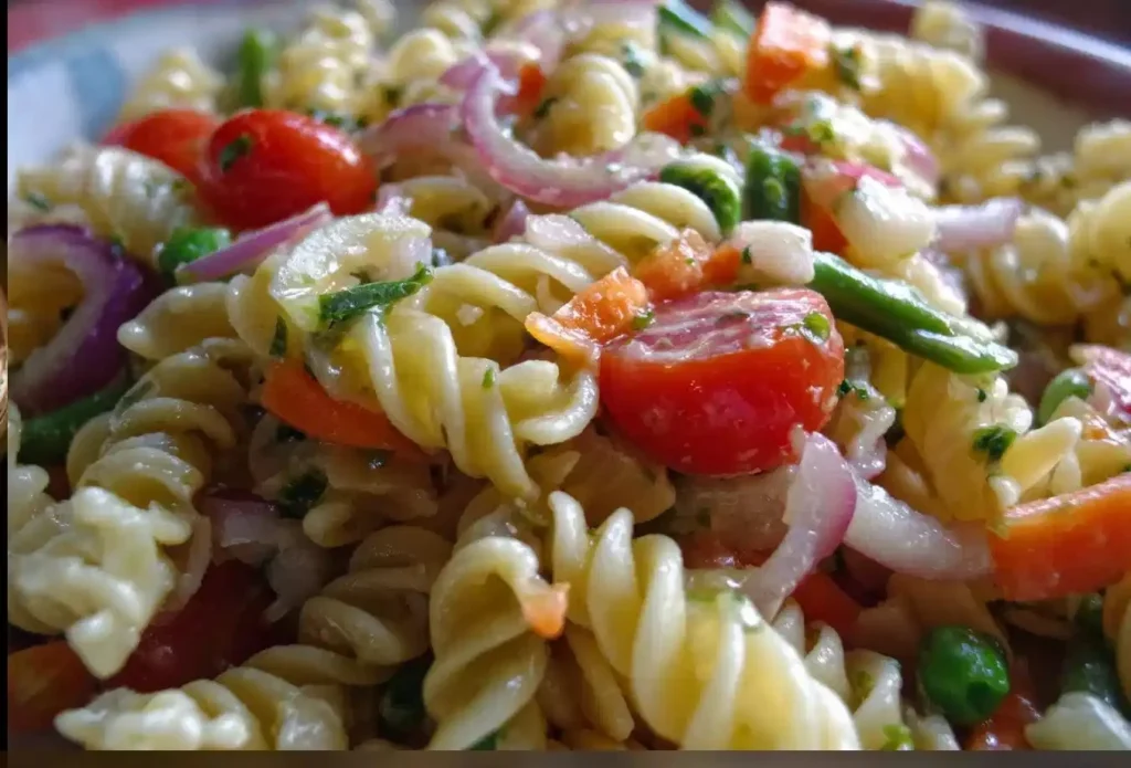 Colorful Italian pasta salad with fresh vegetables and dressing