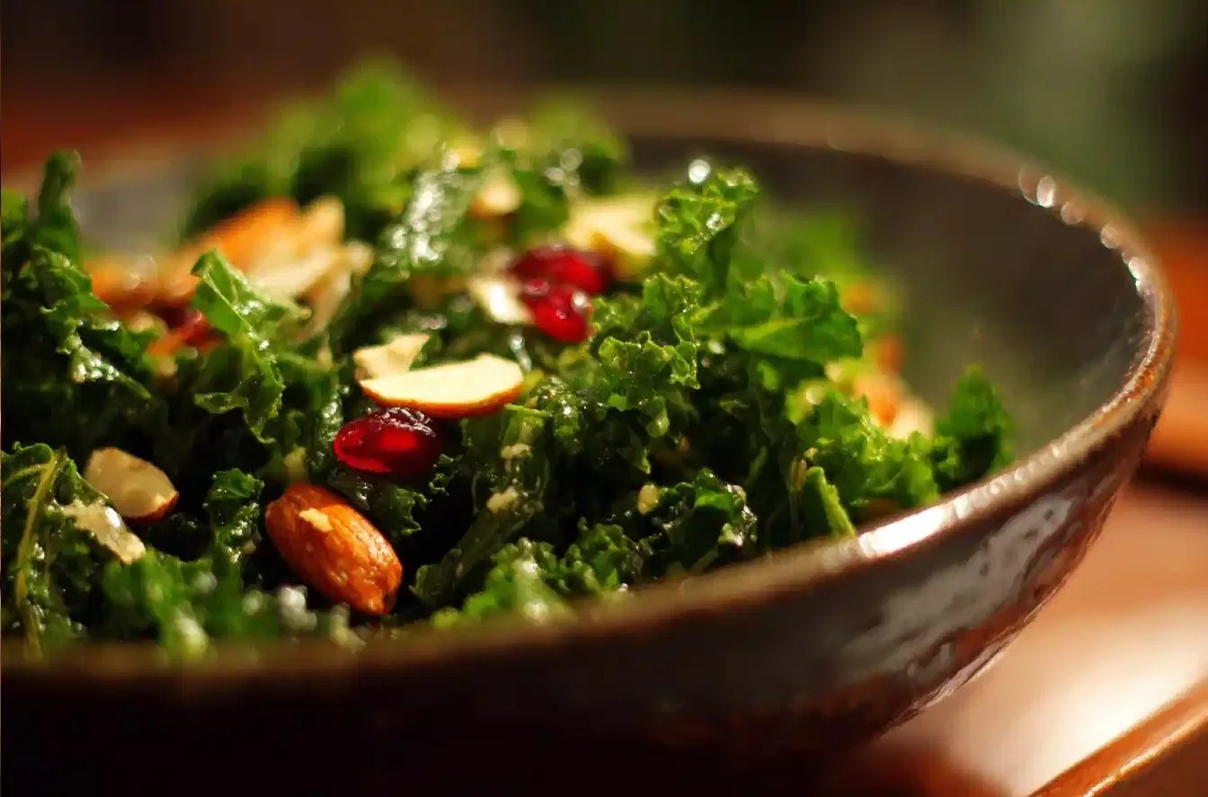Delicious kale salad with fresh vegetables and dressing on a plate