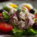 Delicious homemade tuna salad served in a bowl with fresh ingredients.