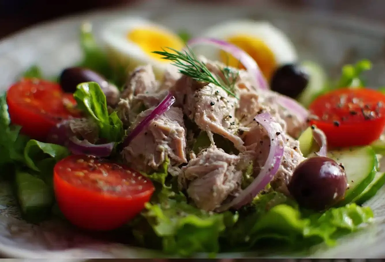 Delicious homemade tuna salad served in a bowl with fresh ingredients.